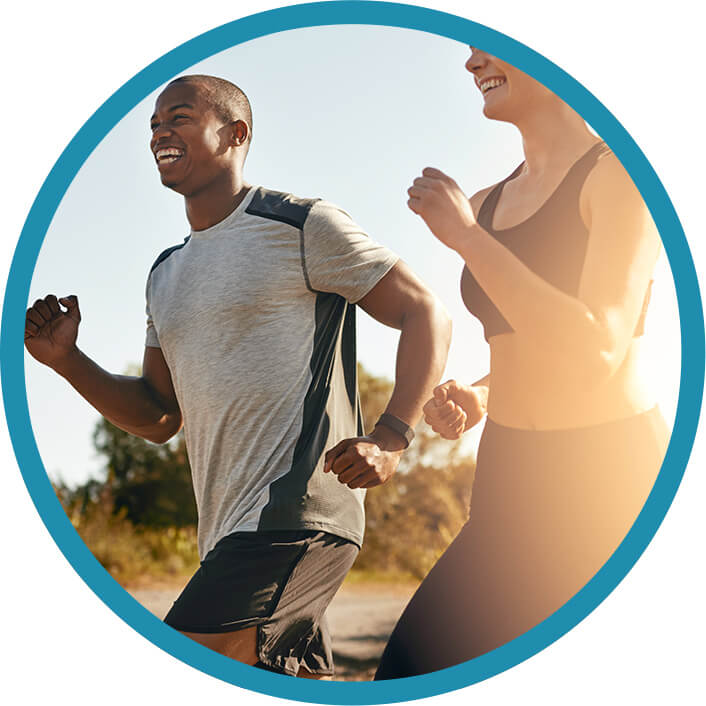 A man and woman running outdoors, smiling and pain-free